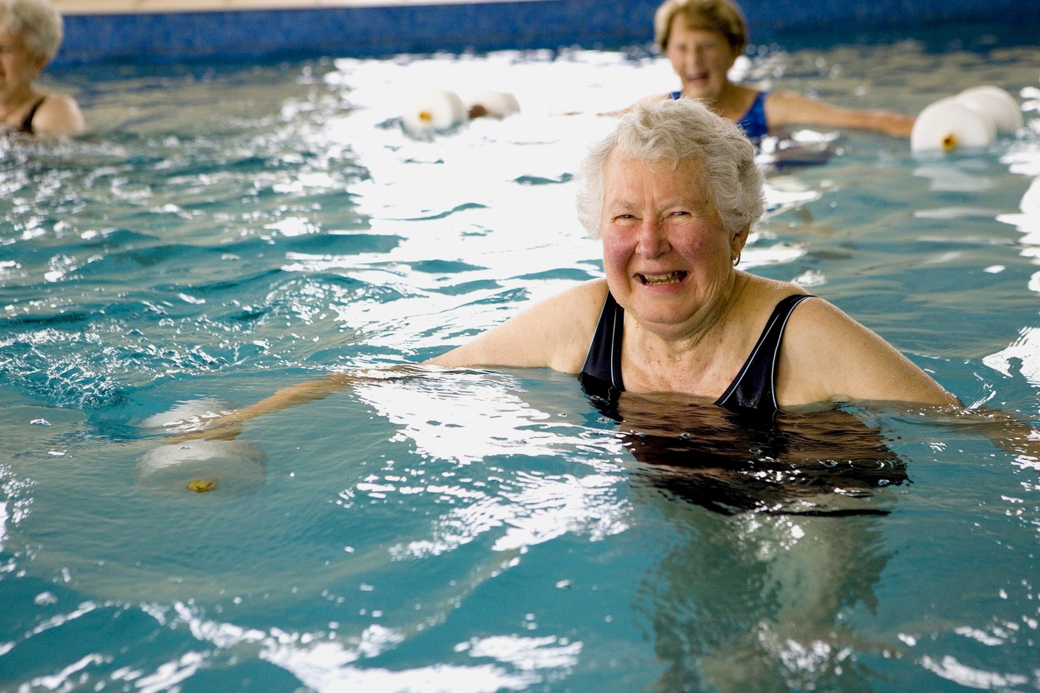 old lady in pool during a hydrotherapy class