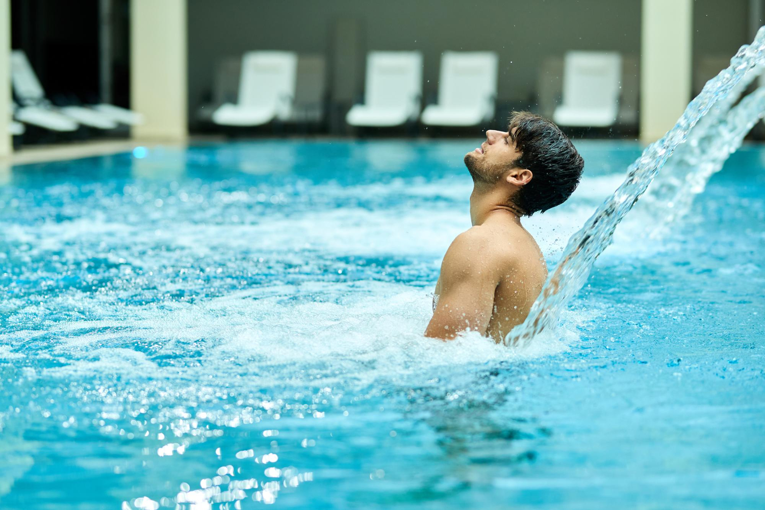 A man undergoing hydrotherapy, submerged in water