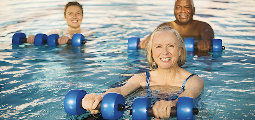 People doing hydrotherapy exercises inside a swimming pool