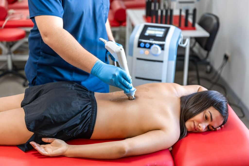 Patient receiving lower back shockwave therapy at AHP Connect rehabilitation facility Sydney